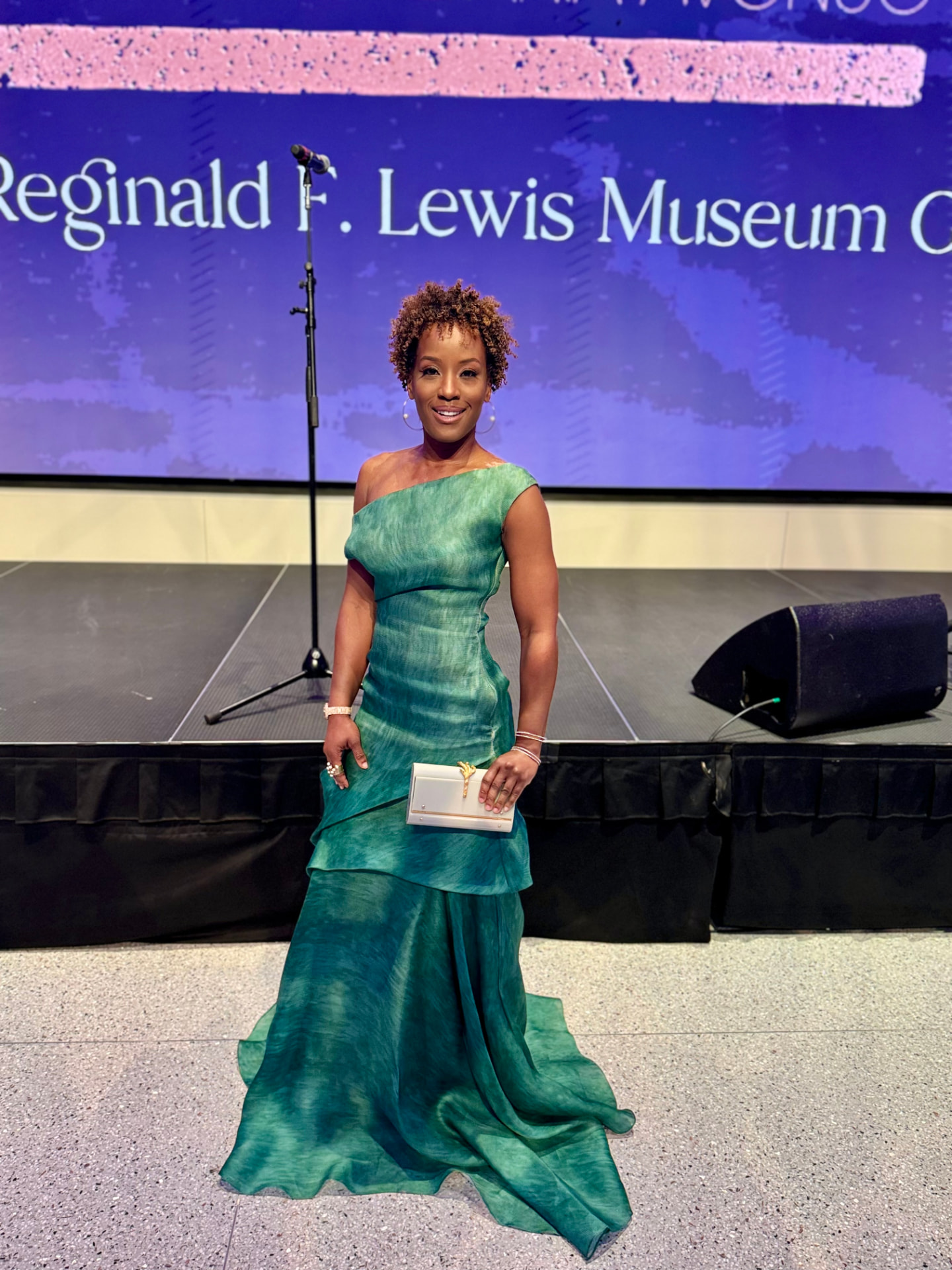 Megan Rivers in a green gown on stage at the Reginald F. Lewis Museum gala
