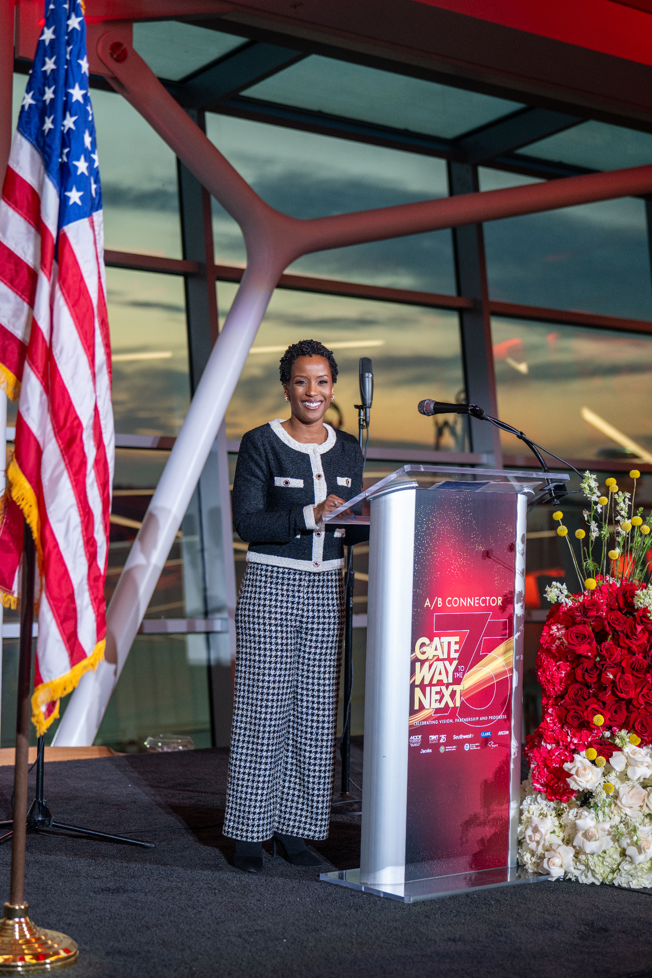 Megan Rivers speaking at a podium during a press event