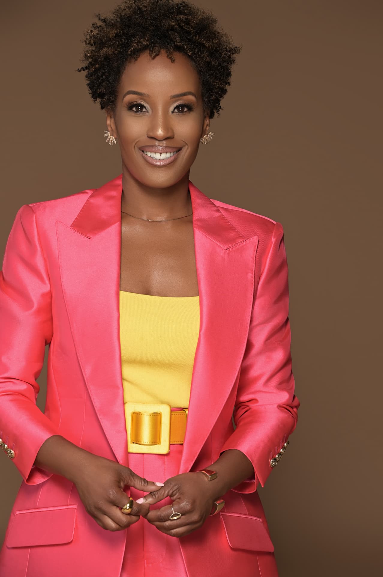 Megan Rivers in a pink satin suit, studio portrait