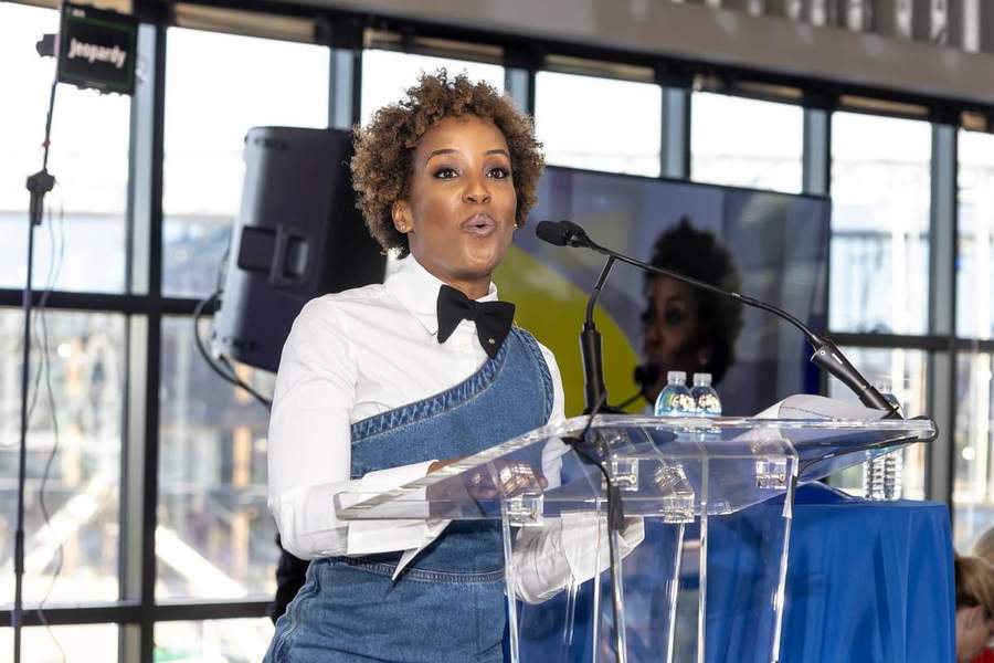 Megan Rivers speaking at a podium